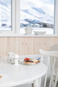 a white table with a plate of food on it at Guesthouse Baegisa in Akureyri