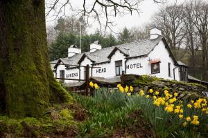 a white house with yellow flowers in front of it at The Queen's Head Hotel in Troutbeck