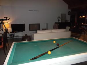 a pool table with balls on it in a living room at Quinta da Tilia Boutique Retreat in Capelas