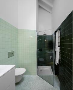 a bathroom with a shower with a toilet and a sink at Quinta da Tilia Boutique Retreat in Capelas +21 photos