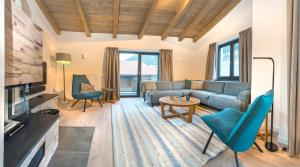 a living room with a couch and a table at Kristall Plaza in Niederau