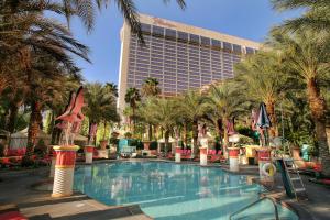 a resort swimming pool with palm trees and a building at Flamingo Las Vegas Hotel & Casino in Las Vegas