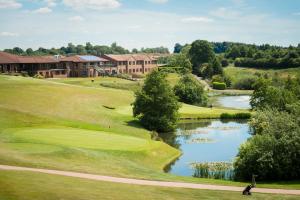 a view of a golf course with a pond at Greetham Valley in Greetham