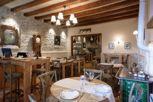 restauracja z drewnianymi stołami i krzesłami w pokoju w obiekcie L'Hotellerie de la Toile à Beurre w mieście Ancenis