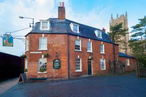 a large red brick building with a clock tower at Castle Hotel in Devizes