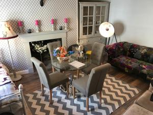 a living room with a table and chairs and a couch at Georgian city apartment at Thomas Street double bedroom and two single trundle beds in Bath