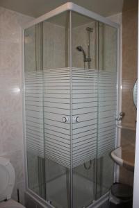 a shower with a glass enclosure in a bathroom at Hotel Sansa in Maastricht +66 photos