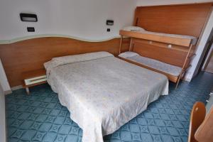 Postel nebo postele na pokoji v ubytování Hotel Rondinella