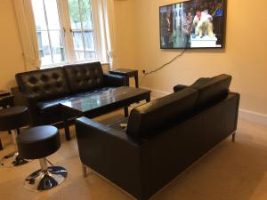 a living room with a couch and a table at Turi House in Canterbury