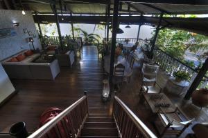 a person sitting on the stairs of a restaurant at Hotel Gerard et Francine in Ambatoloaka
