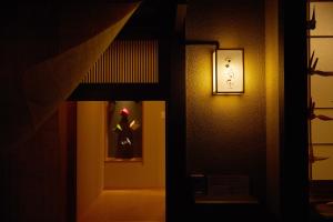 a door in a room with a dress in a window at Miyazakiya in Kyoto