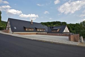 a house with a black roof on a street at Pútnický mlyn in Marianka