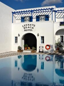 a large white swimming pool with a blue sky at Levante Beach Hotel in Kamari