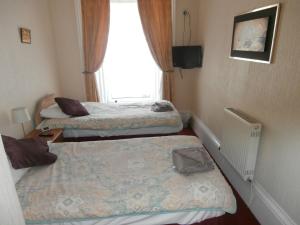 Postel nebo postele na pokoji v ubytování Monorene Guest House
