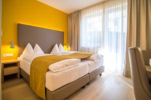 Postel nebo postele na pokoji v ubytování Garni Hotel Kessler