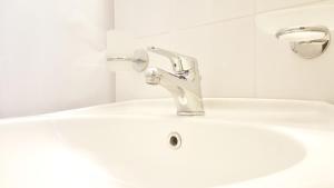 a bathroom sink with a silver faucet at Hotel Mare Blu -- boutique in Pineto