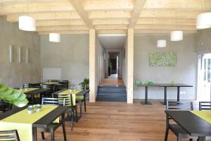 a dining room with tables and chairs and a hallway at Rüedi - WeinFassHotel in Trasadingen