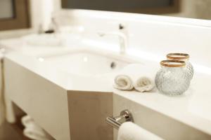 a bathroom with two sinks and a vase on a counter at Holiday Inn Bursa - City Centre by IHG in Bursa