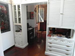 um quarto com uma cómoda e um armário com armários brancos em Abitazione Pigneto B&B em Roma