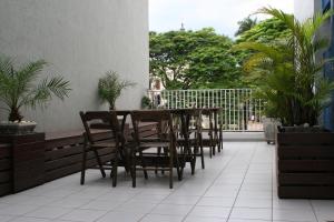 a table and chairs on a balcony with plants at Patriarca Hotel in Itapeva