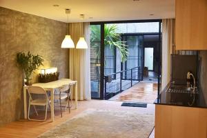 a kitchen and a dining room with a table and a dining room at Baan Mali Apartment in Chiang Mai