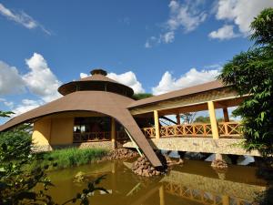 a building with a bridge over a body of water at Kilima Safari Camp in Amboseli
