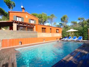 a house with a swimming pool in front of a house at Villa Bel in Begur