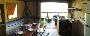 a kitchen with a table and a sink in a house at Camping Les Grillons in Embrun