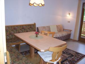 a living room with a table and a couch at Haus Emberger in Gerlos