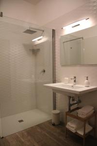 a bathroom with a sink and a shower with a mirror at Principe in Bari