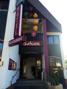 a restaurant with umbrellas hanging off the side of a building at Saigon Hotel in Homburg