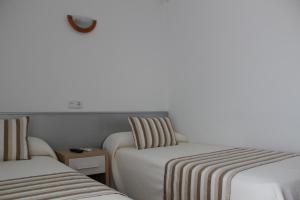 Postel nebo postele na pokoji v ubytování Hostal Masin