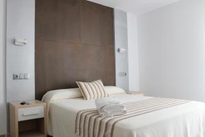 Postel nebo postele na pokoji v ubytování Hostal Masin