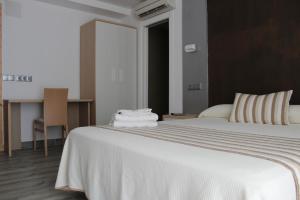 Postel nebo postele na pokoji v ubytování Hostal Masin