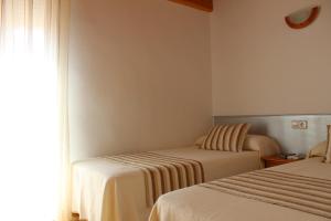 Postel nebo postele na pokoji v ubytování Hostal Masin