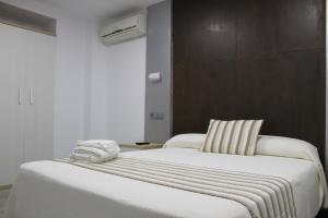 Postel nebo postele na pokoji v ubytování Hostal Masin