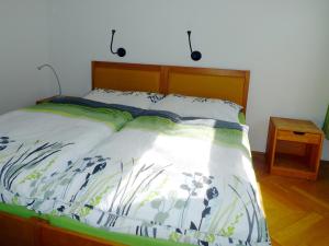 a bedroom with a bed with a wooden headboard at City Apartments Wien - Viennapartment in Vienna