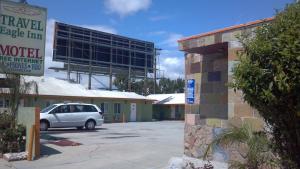 a car parked in a parking lot in front of a motel at Travel Eagle Inn Motel in Long Beach