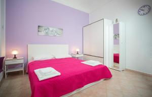 a bedroom with a large red bed with a mirror at Casa del Clown in Trapani
