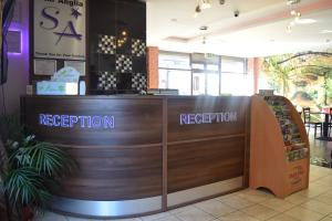 a reception desk in a restaurant with a sign that reads reception at Star Anglia Hotel in Colchester