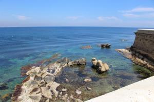 a view of the ocean with rocks in the water at Hostal Masin in Tabarca