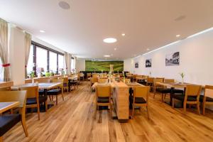 a dining room with wooden tables and chairs at Hotel Zum Rebstock in Malterdingen