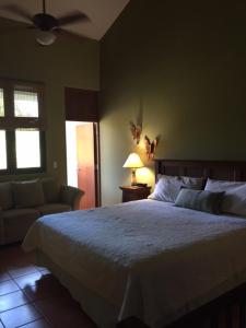 a bedroom with a large bed and a couch at Rio Mar Village - Golf Course View in Rio Grande