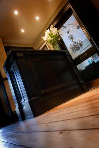 a black door with a vase of flowers on top at The Grafton in Harrogate