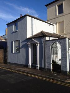 a white house on the side of a street at Victorian Cottage - The Beach Walmer in Walmer