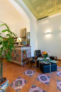 a living room with a couch and a table at Don Pedro Rooms in the city center in Naples