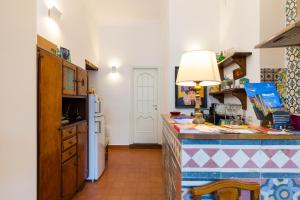 a kitchen with a counter and a refrigerator at Don Pedro Rooms in the city center in Naples
