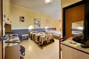 Postel nebo postele na pokoji v ubytování Albergo Mancuso del Voison
