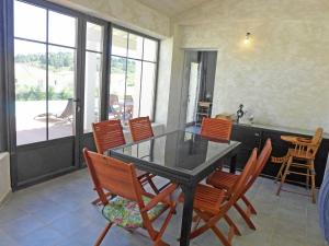 a dining room with a glass table and chairs at Beautiful Holiday Home with Swimming Pool in Narbonne in Narbonne
