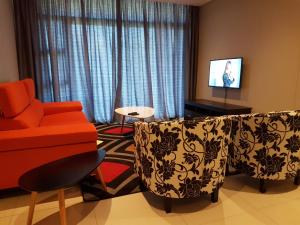 a living room with a couch and a chair at Zimbali Suites 106 in Ballito